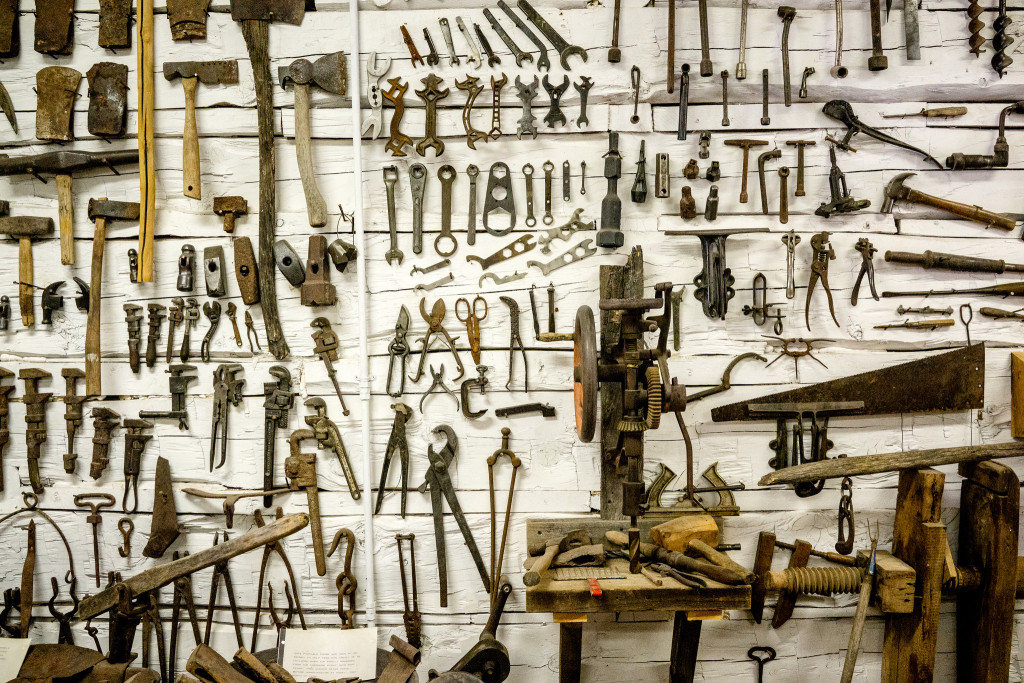 A photo of various assorted tools hung on a wall, published as part of The Sharpest Tool for Businesses Is a UX Toolkit