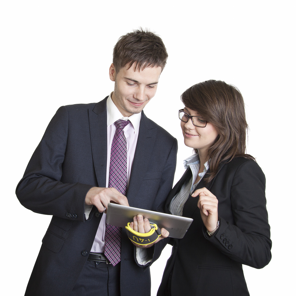 Two business people looking at a tablet, Published as part of 