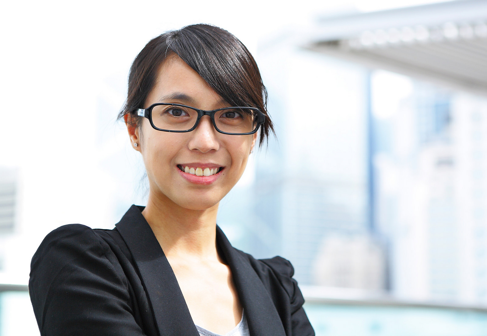 A smiling woman in a business suit, published as part of: "How To Be A Good Client"