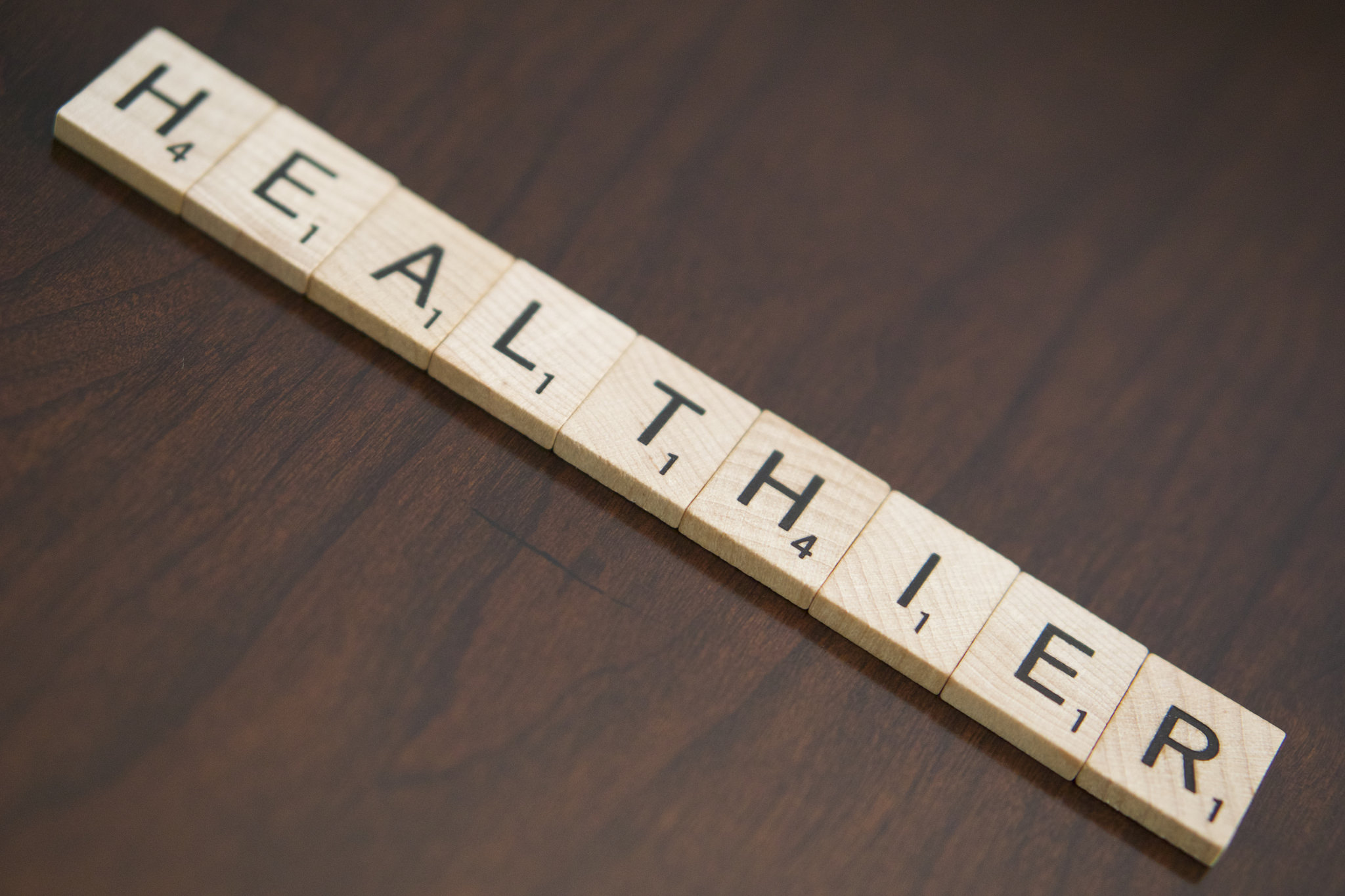 The word "Healthier" spelled out in Scrabble tiles, published as part of "How Healthcare Organizations Can Use Social Media for Relationship-Building"