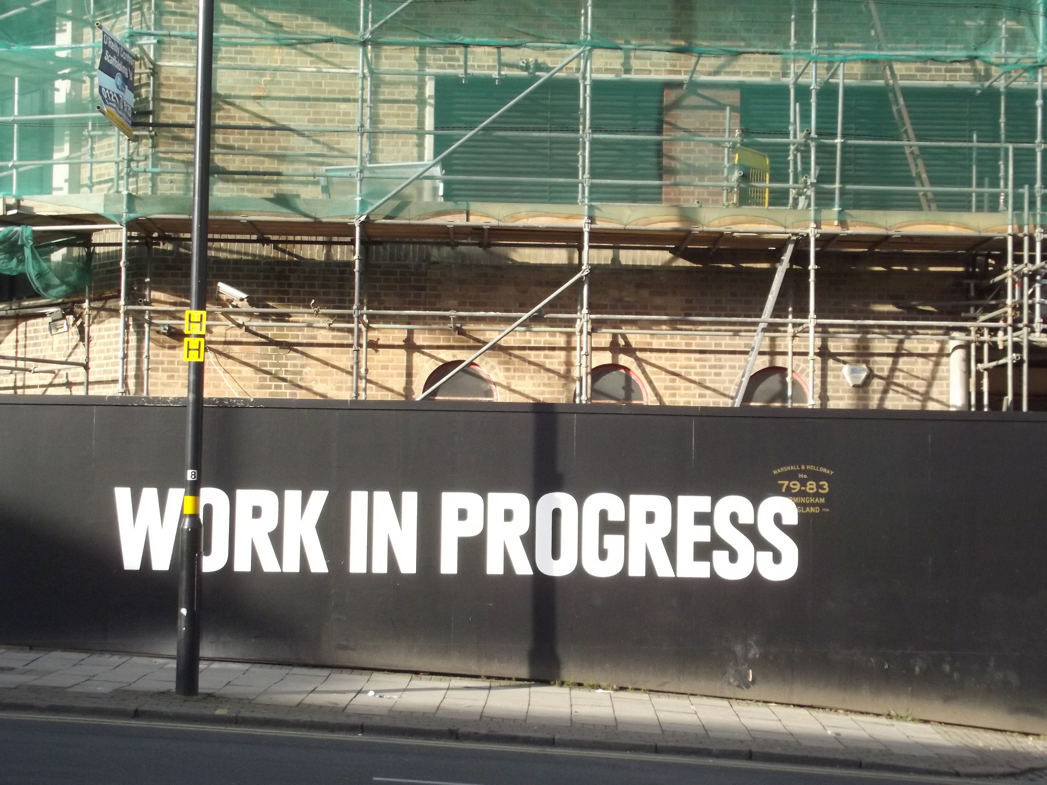 The words "Work in Progress" over a building being refinished, published as part of: "The Complete Guide to Content Marketing for Small Business, Part 3: Improving Over Time"