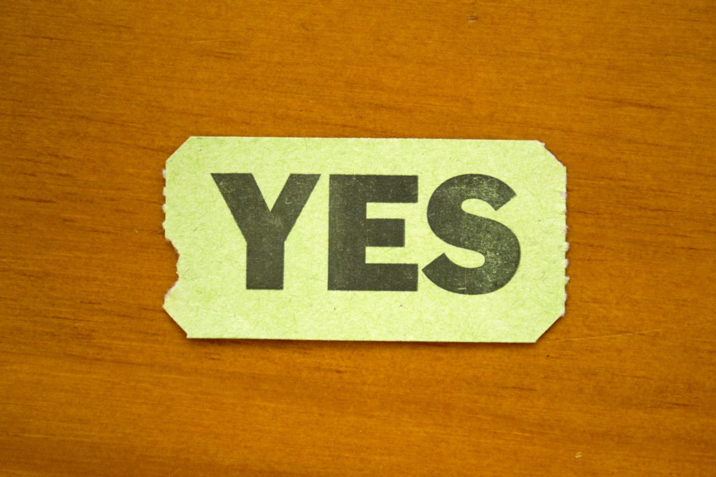 The word "yes" written on a piece of paper on a wooden table, published to "3 Tips for Launching a New Website for Your Small Business or Non-Profit"