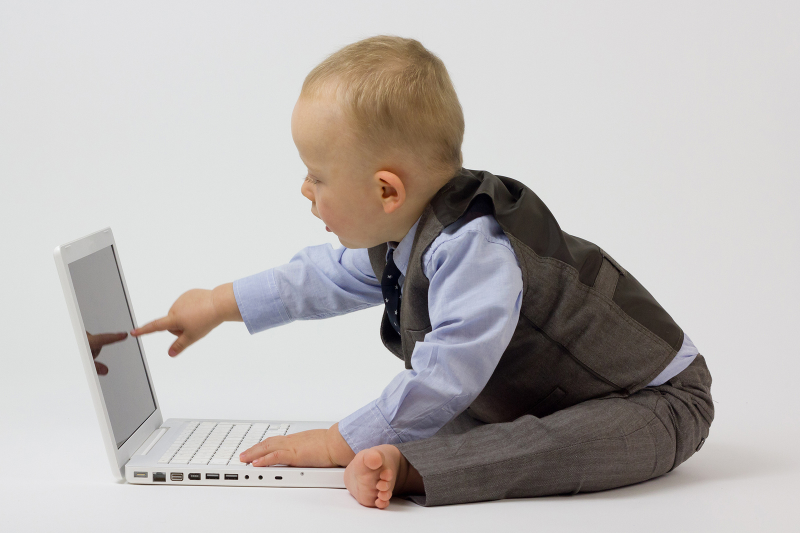 A baby in business attire pointing at a laptop, published to "3 Tips for Creating Great Content Marketing Collateral"