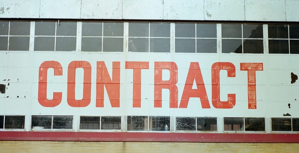 The side of a building with the word "contract" on it, published to "Why You Shouldn't Sign a 12 Month Website Contract"